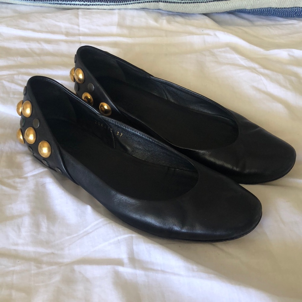 Gucci flats with gold stud accents on the back.